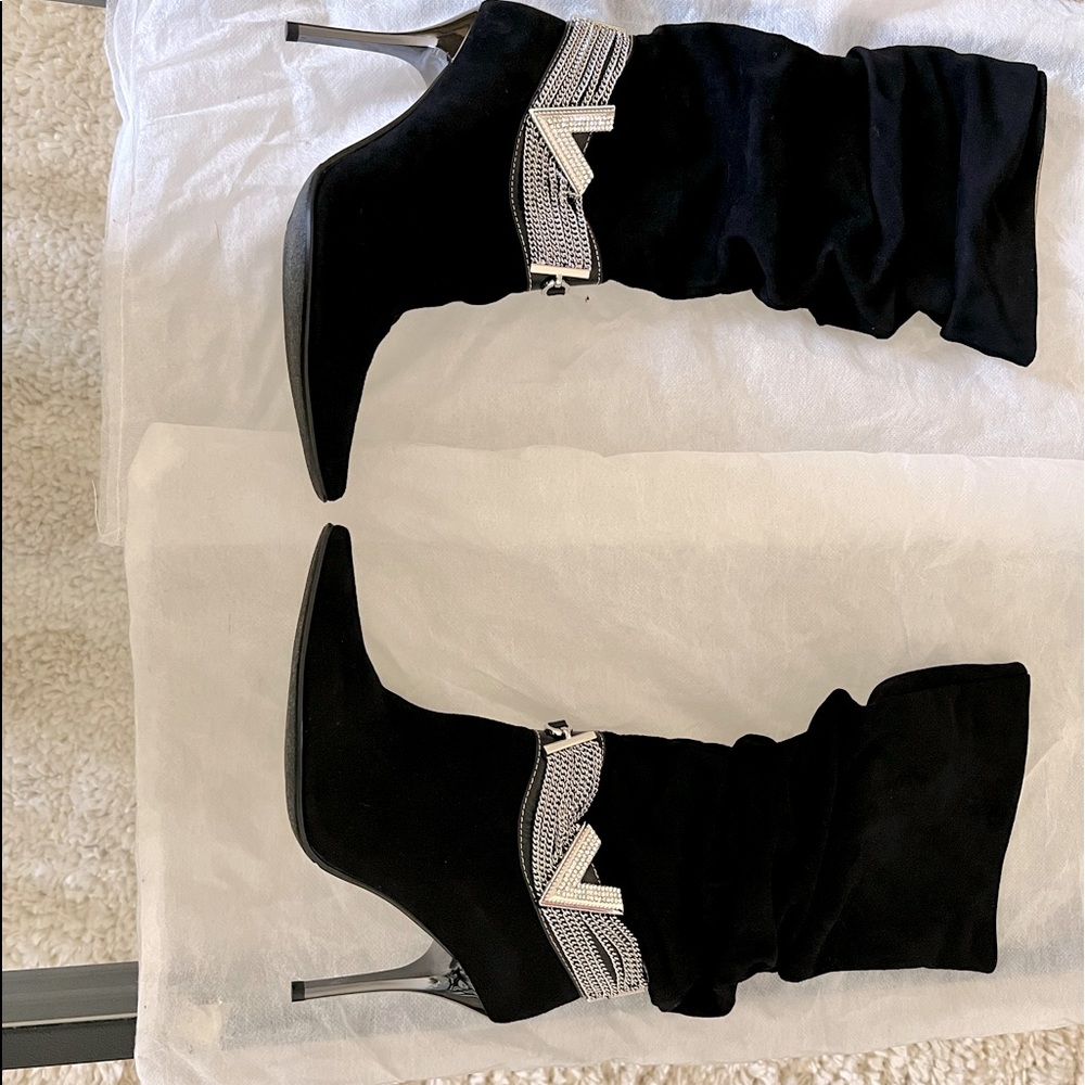 Pointed toe Mid-calf slouchy stiletto suede boots with a silver-tone chain.